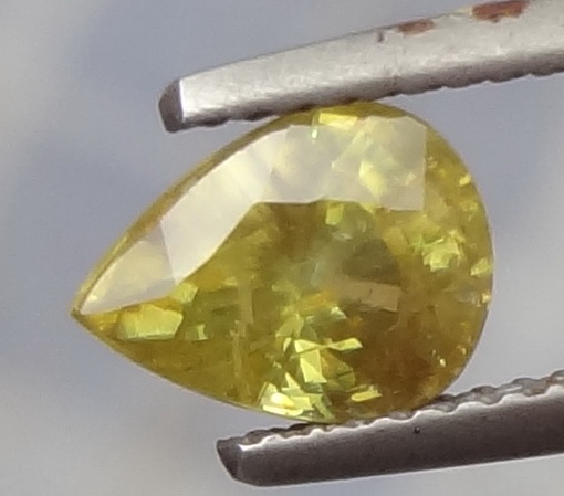 Drop cut yellow sphene gemstone. 