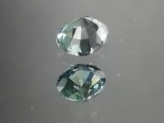 Green oval sapphire with dashes of blue, very clean and shiny small sapphire from Thailand. 